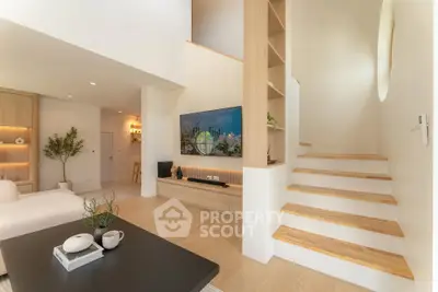 Modern living room with stylish staircase and built-in shelving