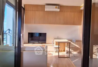 Modern living room with natural light, featuring a cozy sofa, TV, and dining area with wooden accents.