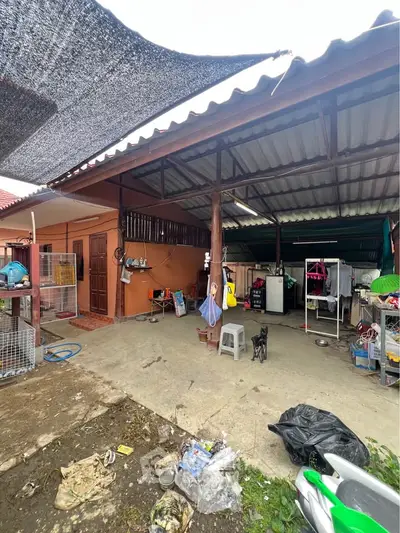 Spacious outdoor area with covered patio and laundry space in a residential property.