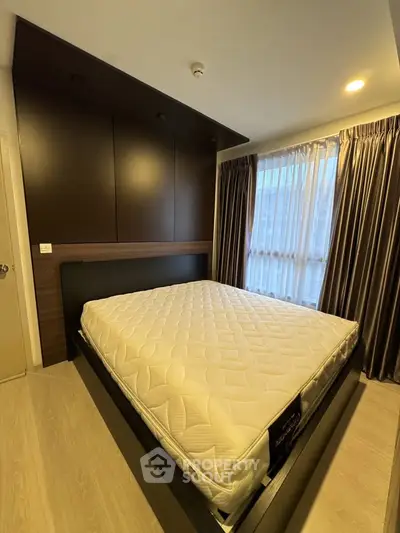 Modern bedroom with stylish dark wood paneling and large window with curtains