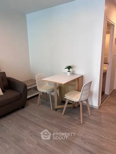 Cozy modern living area with compact dining set and stylish flooring