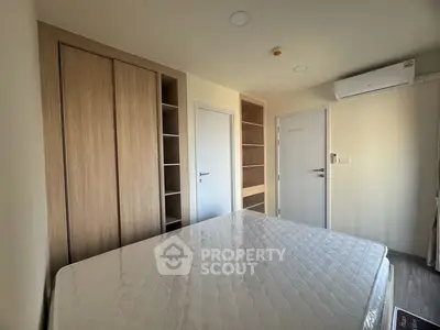 Modern bedroom with built-in wardrobe and air conditioning unit