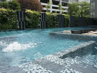 Luxurious residential pool with modern design and lush greenery for ultimate relaxation.