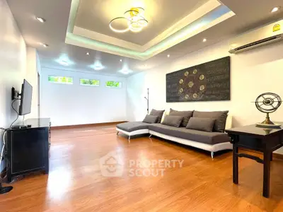 Spacious modern living room with stylish decor and ample natural light.