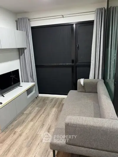 Modern living room with sleek gray sofa and stylish entertainment unit