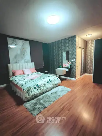 Luxurious bedroom with elegant decor and plush bedding in modern apartment.