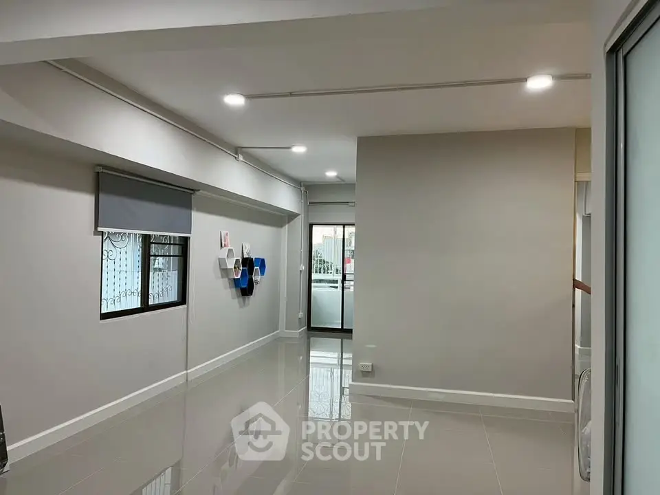 Spacious modern living room with glossy floors and stylish wall decor