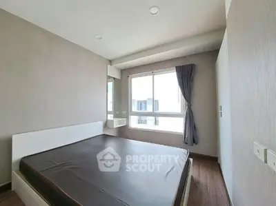 Modern bedroom with large window and minimalist design