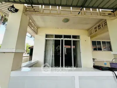 Charming outdoor patio with sliding glass doors and tiled counter, perfect for entertaining.