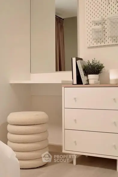Chic modern bedroom corner with stylish dresser and cozy stool