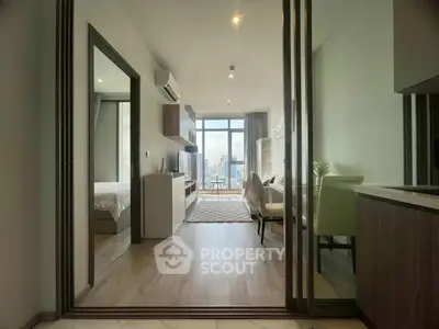 Modern apartment interior with open layout and city view, featuring stylish living room and bedroom.