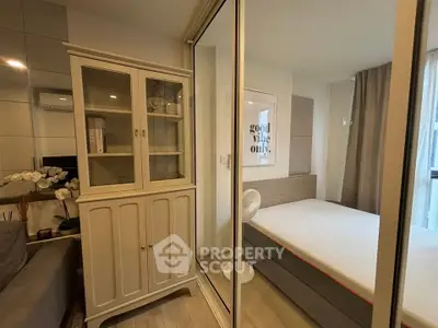 Cozy bedroom with glass partition and stylish decor in modern apartment.