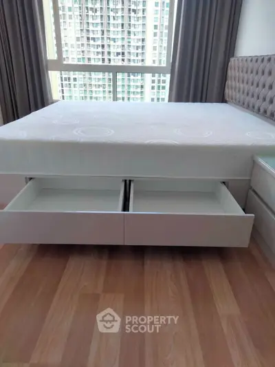 Modern bedroom with storage bed and city view window