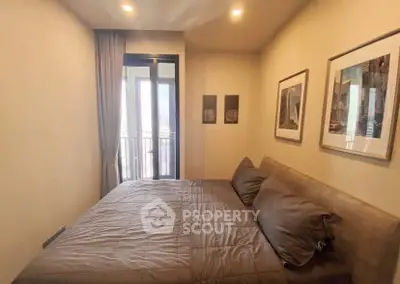 Cozy bedroom with modern decor and balcony access in a stylish apartment.