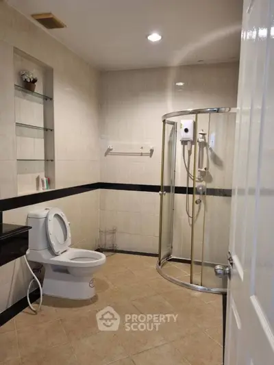 Spacious bathroom with modern shower and toilet in elegant design