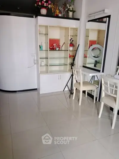 Modern interior with sleek white shelving and elegant chairs, perfect for a stylish living space.