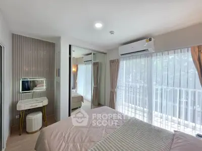 Bright and airy bedroom with large windows and balcony access, featuring modern decor and air conditioning.