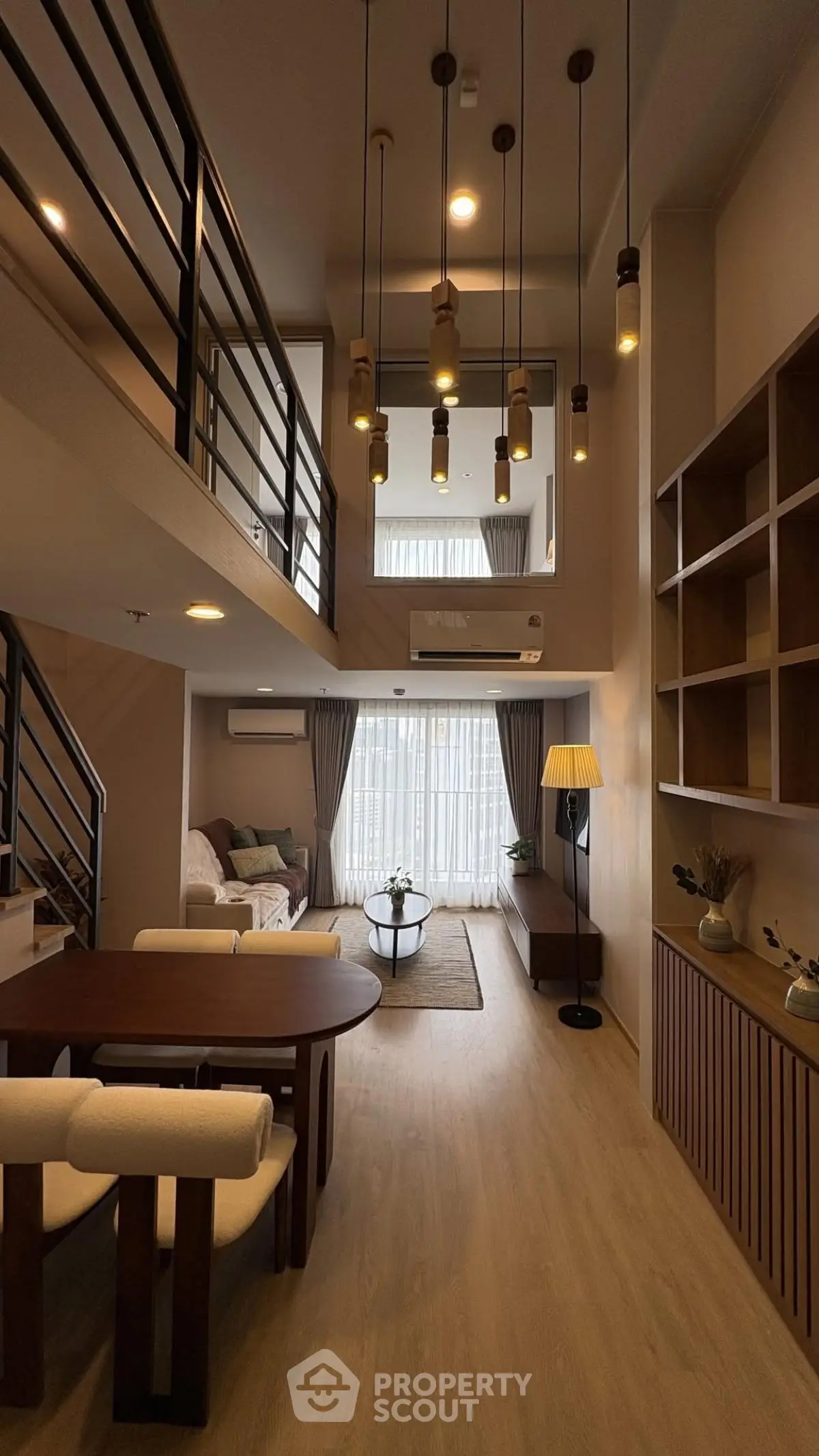 Stunning duplex living room with high ceilings and modern decor