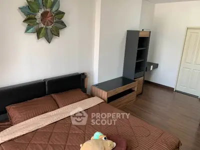 Modern bedroom with stylish decor and wooden flooring