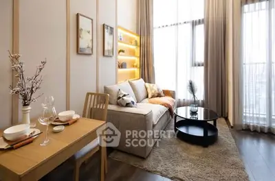 Modern living room with cozy sofa, elegant decor, and large window offering natural light.