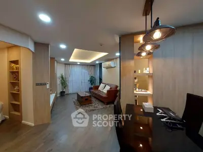 Spacious modern living room with stylish lighting and cozy seating area.