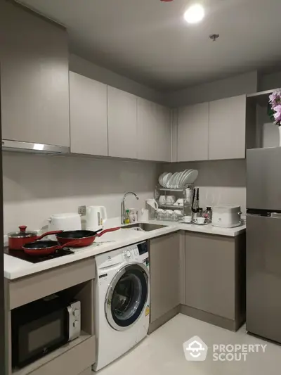 Modern kitchen with washing machine and sleek cabinetry