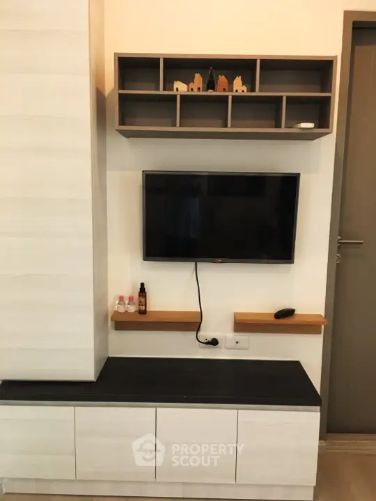 Modern living room with sleek TV setup and stylish shelving