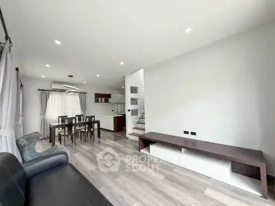 Spacious modern living room with open layout and stylish dining area, perfect for entertaining.