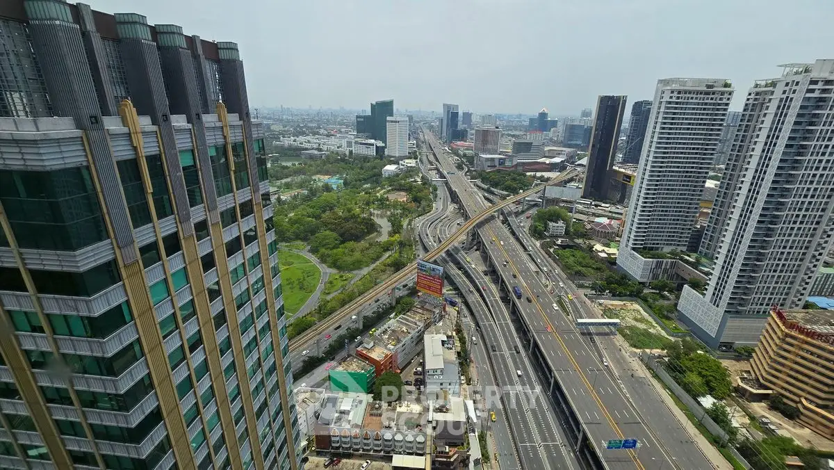Stunning cityscape view from high-rise building overlooking highways and modern architecture.