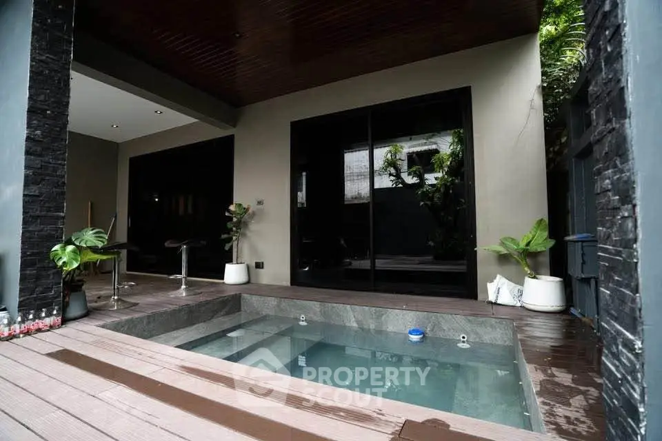 Luxurious modern home with private outdoor pool and stylish patio area.