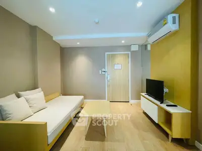 Modern living room with minimalist furniture and air conditioning in a cozy apartment.