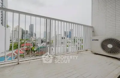 Spacious balcony with city view and air conditioning unit, perfect for urban living.