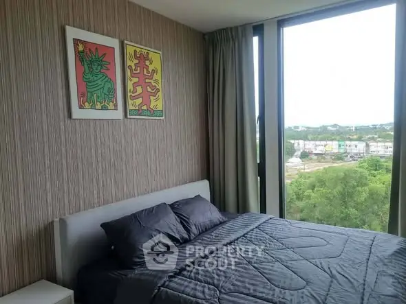 Modern bedroom with large window offering scenic views and stylish decor.