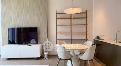 Modern living room with stylish furniture and open kitchen layout