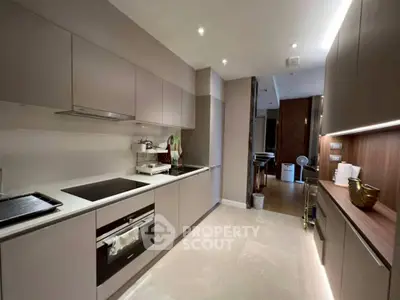 Modern kitchen with sleek cabinetry and built-in appliances in a contemporary apartment.
