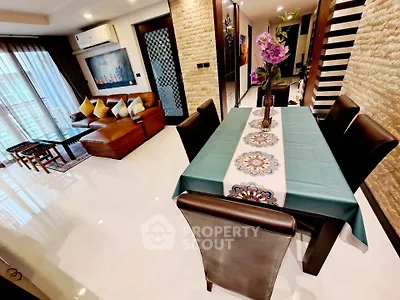 Luxurious open-plan living and dining area with modern decor and elegant furnishings.