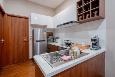 Modern kitchen with sleek cabinetry, stainless steel appliances, and wooden accents for a stylish cooking space.