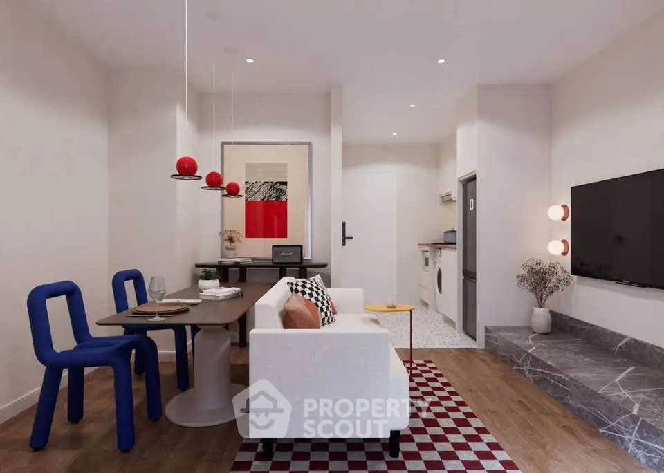 Modern living room with stylish decor, open layout, and vibrant accents in a cozy apartment.