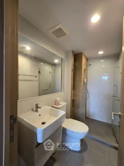Modern bathroom with sleek fixtures and glass shower enclosure