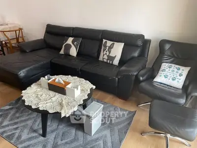 Stylish living room with black leather sofa and modern decor