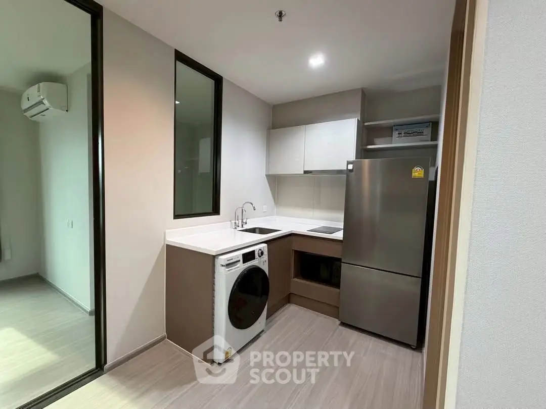 Modern kitchen with sleek appliances and open layout in a stylish apartment.