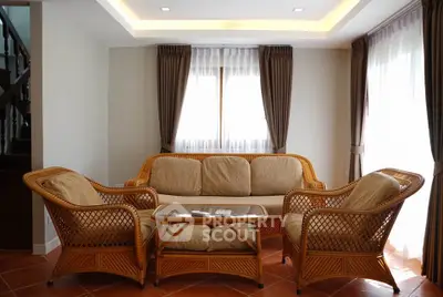 Charming living room with wicker furniture and natural light, perfect for cozy gatherings.