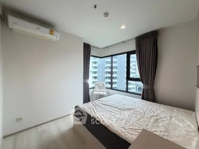 Modern bedroom with large windows and city view in a high-rise apartment