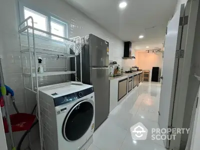 Modern kitchen with sleek appliances and ample storage space