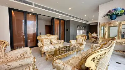 Luxurious living room with ornate furniture and elegant decor in a high-end apartment.