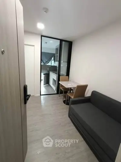 Modern compact living space with sleek kitchen and cozy seating area, perfect for urban living.