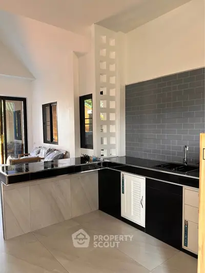 Modern kitchen with sleek black countertops and open layout design