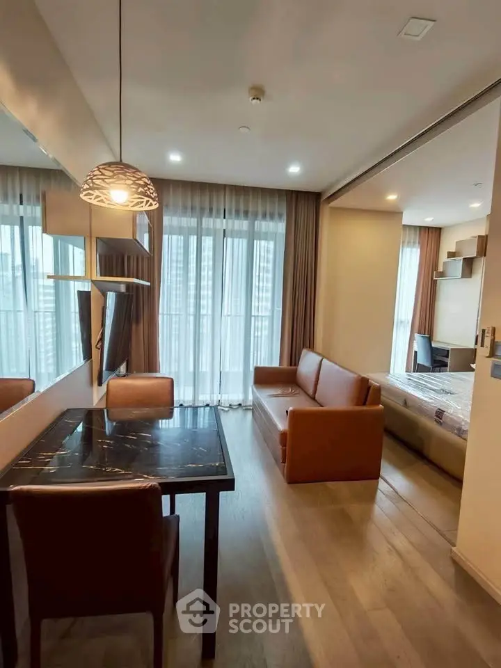Modern living room with stylish furniture and large windows in a contemporary apartment.