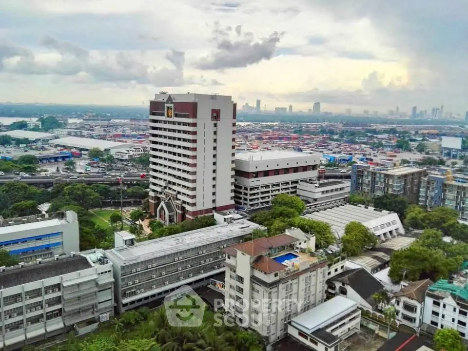 Stunning aerial view of urban landscape with high-rise buildings and lush greenery.