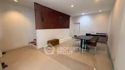 Spacious modern living room with sleek tile flooring and stylish dining area.